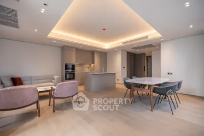 Modern open-plan living room with stylish kitchen and elegant dining area in luxury apartment.