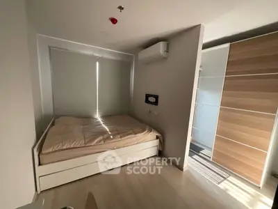 Modern bedroom with sleek design, featuring a cozy bed, built-in wardrobe, and air conditioning for ultimate comfort.