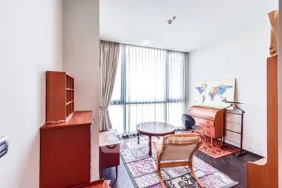 Charming study room with elegant wooden furniture and large window for natural light.