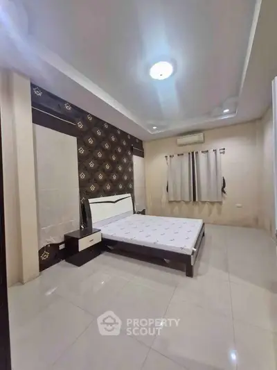 Spacious bedroom with modern decor and ample natural light