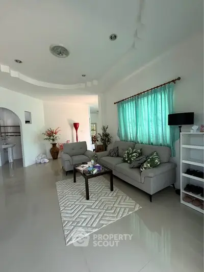 Spacious living room with modern decor and natural light