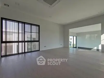 Spacious modern living room with large windows and natural light