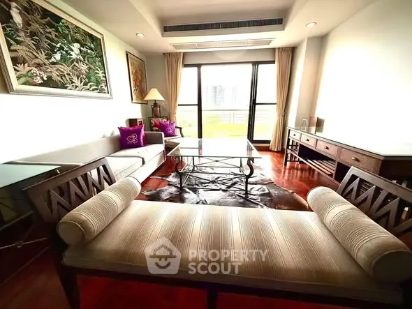Spacious living room with elegant furniture and large windows offering natural light.
