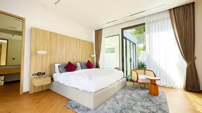 Luxurious bedroom with modern decor, large windows, and elegant furnishings in a stylish home.