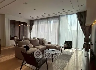 Luxurious modern living room with floor-to-ceiling windows and elegant decor in a high-rise apartment.