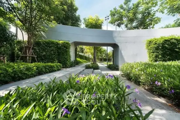 Lush green garden with modern architectural elements and vibrant flowers.