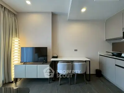 Modern living room with sleek furniture and open kitchen layout