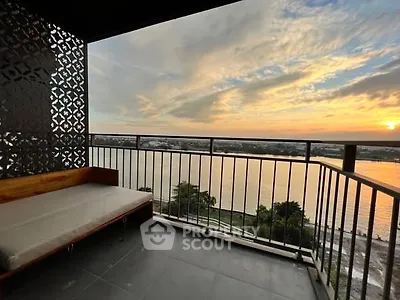 Stunning balcony with breathtaking river view at sunset, perfect for relaxation and enjoying nature.