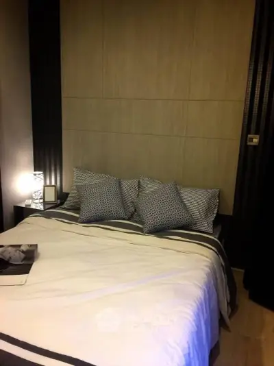 Cozy modern bedroom with stylish decor and ambient lighting, perfect for relaxation and comfort.
