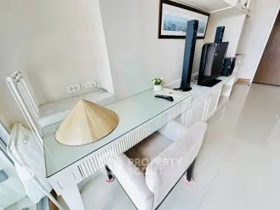 Modern living room with sleek glass desk and entertainment center