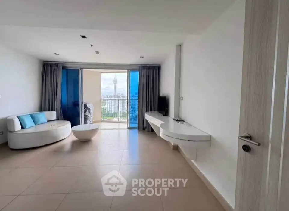 Spacious modern living room with balcony and stunning city view