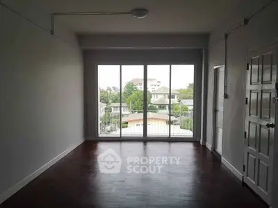 Spacious empty room with large windows offering a scenic view, perfect for customization.
