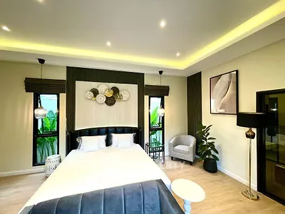 Luxurious bedroom with modern decor and ambient lighting, featuring a stylish bed and elegant furnishings.