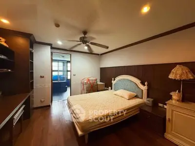 Spacious bedroom with elegant decor and wooden flooring