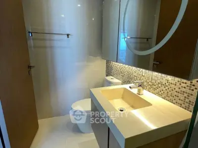 Modern bathroom with sleek fixtures and stylish mosaic backsplash