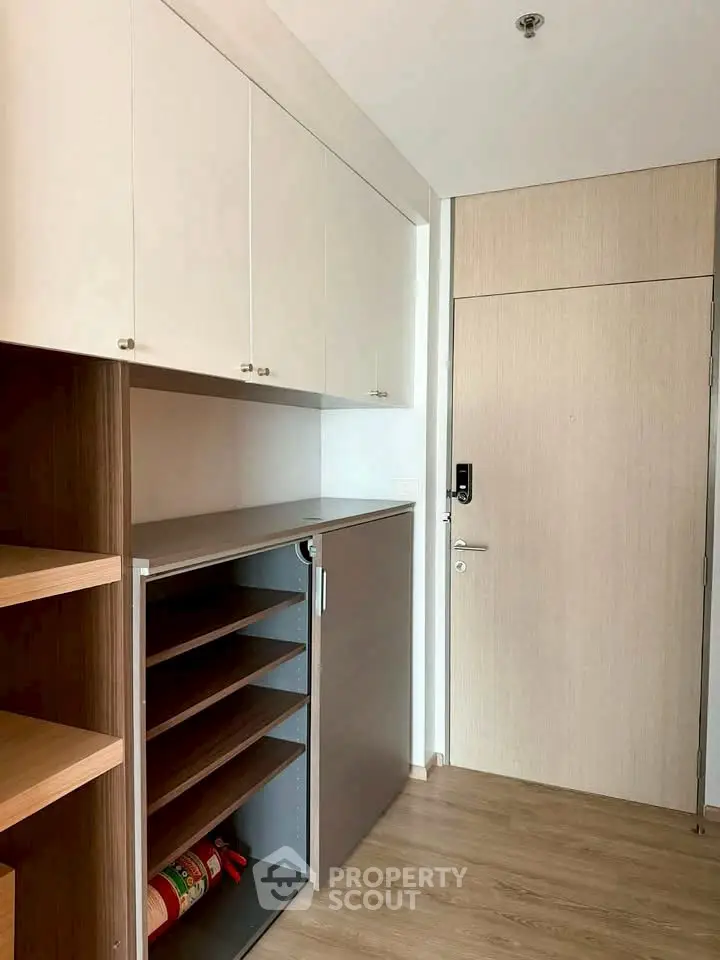 Modern storage area with sleek cabinets and wooden flooring