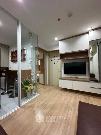 Modern living room with wooden flooring and built-in TV unit