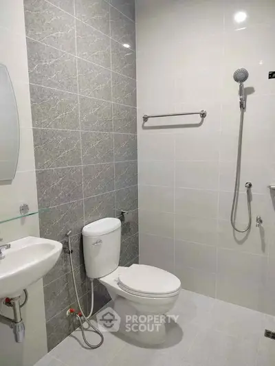 Modern bathroom with sleek fixtures and tiled walls in a contemporary home.