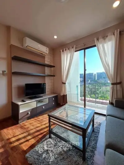 Bright living room with modern decor and balcony view in urban apartment.