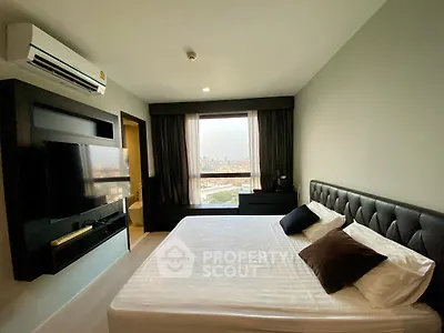 Modern bedroom with city view, featuring a sleek design and comfortable furnishings.