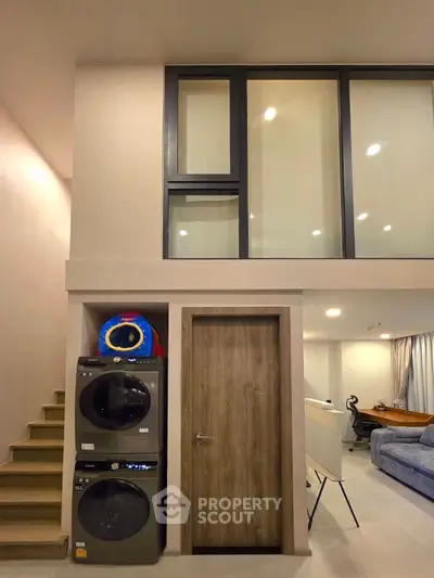 Modern duplex interior with laundry area and stylish staircase