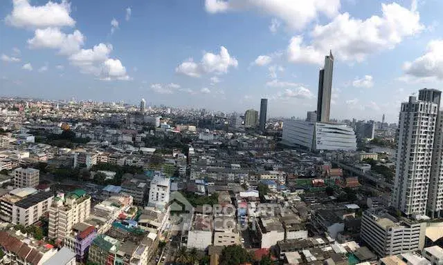 Stunning cityscape view showcasing urban skyline with high-rise buildings under a clear blue sky.