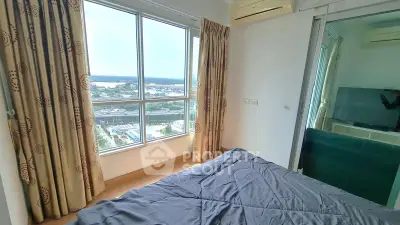 Bright bedroom with large window offering stunning city view, featuring modern decor and air conditioning.