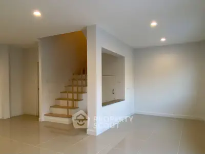 Spacious modern interior with staircase and glossy tiled flooring