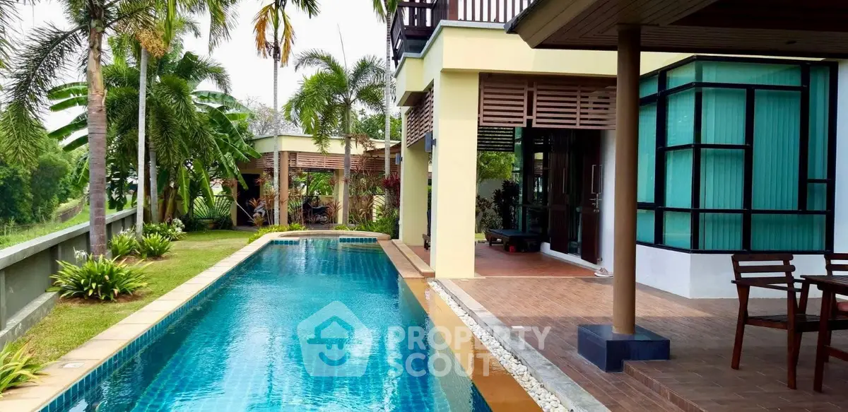 Luxurious modern home with stunning pool and lush garden view