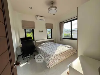 Cozy bedroom with natural light and modern furnishings