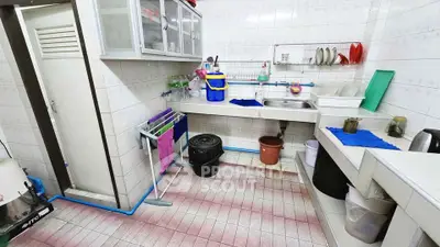 Functional kitchen with ample storage and tiled backsplash, featuring a practical layout for efficient cooking.