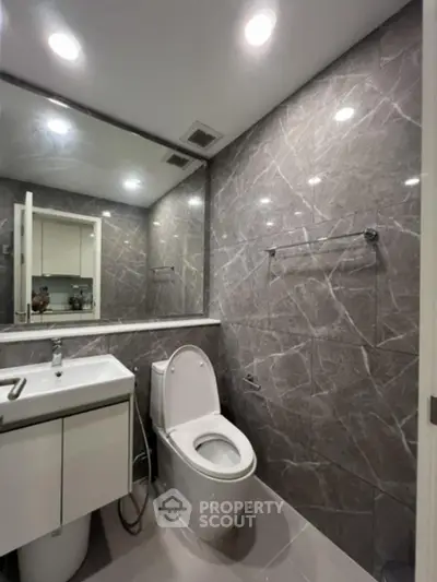 Modern bathroom with sleek marble tiles and contemporary fixtures