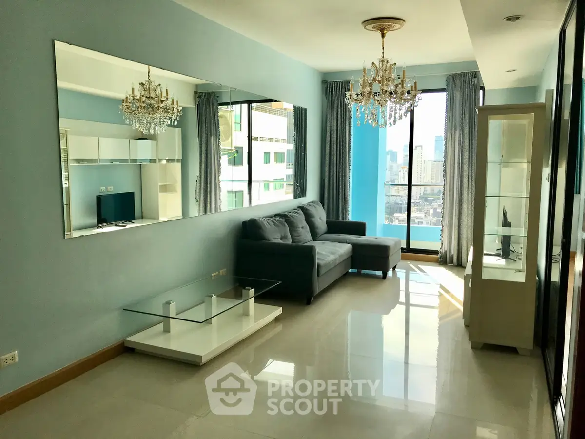 Spacious living room with elegant chandeliers and city view in modern apartment