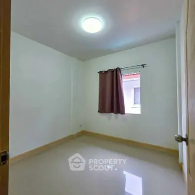 Minimalist empty bedroom with glossy floor and single window, perfect for customization.