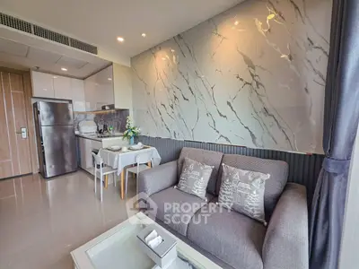 Modern living room with stylish decor and open kitchen layout in a contemporary apartment.