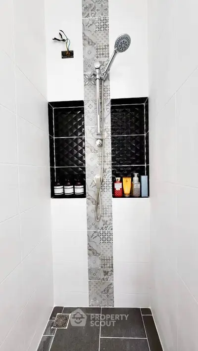 Modern bathroom shower with stylish black and white tile design