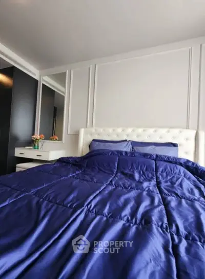 Luxurious bedroom with plush blue bedding and elegant decor