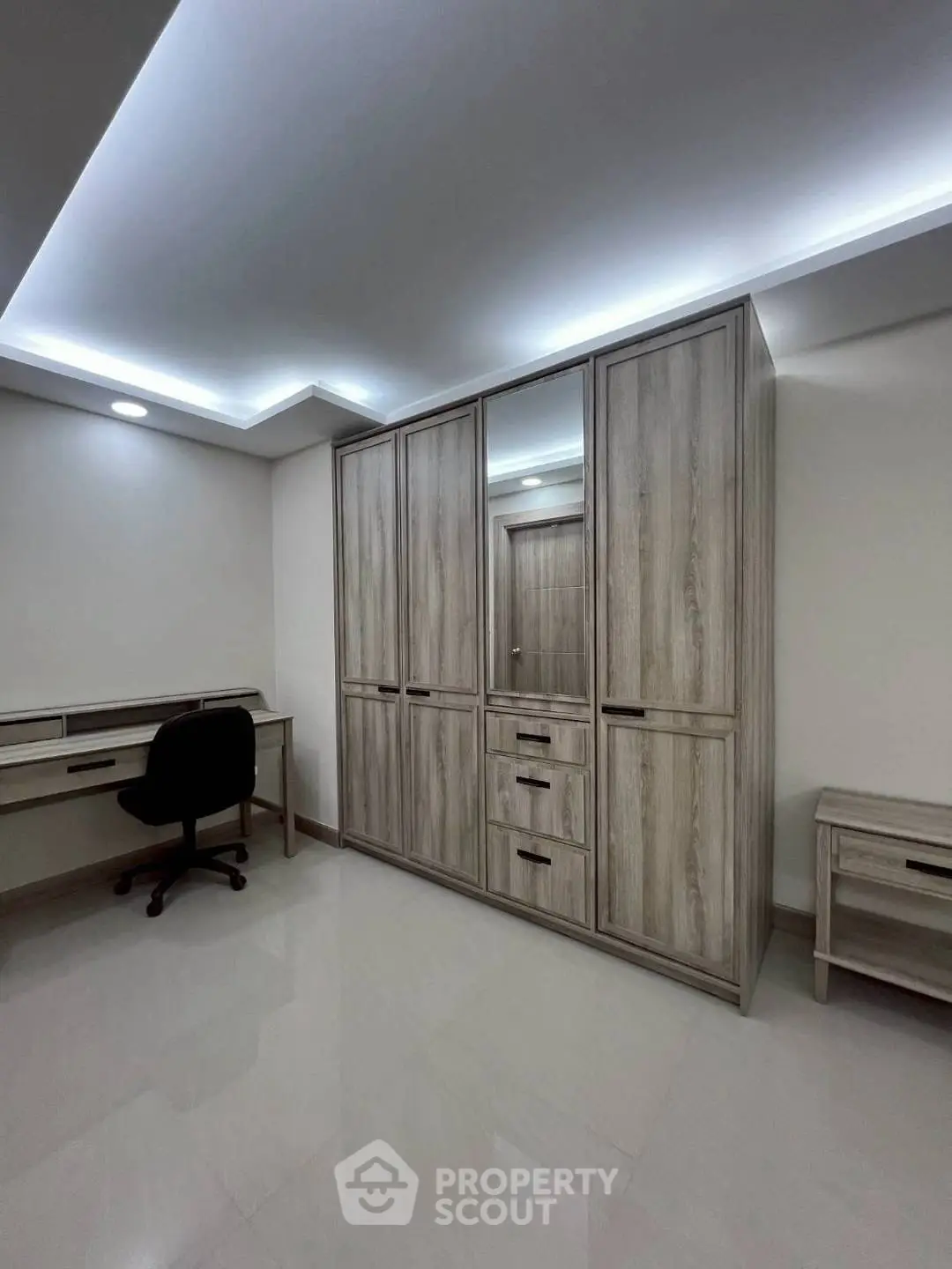 Spacious study room with modern desk and large wardrobe
