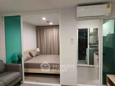 Modern apartment interior with bedroom and kitchen, featuring sleek design and efficient use of space.