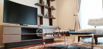 Stylish living room with modern TV unit and cozy seating area.