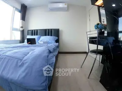 Modern bedroom with blue bedding, air conditioning, and sleek workspace