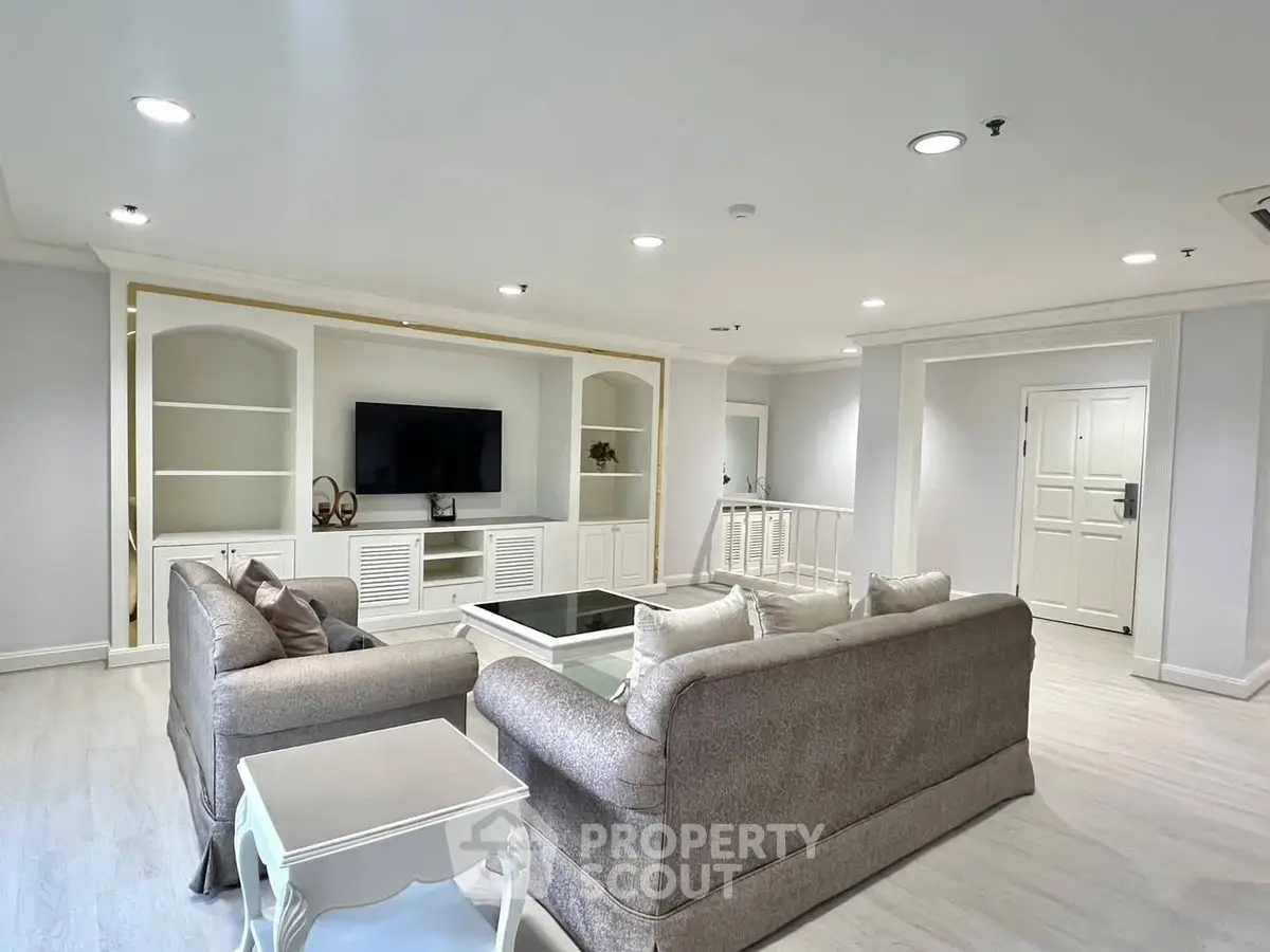 Spacious living room with elegant furniture and built-in entertainment center