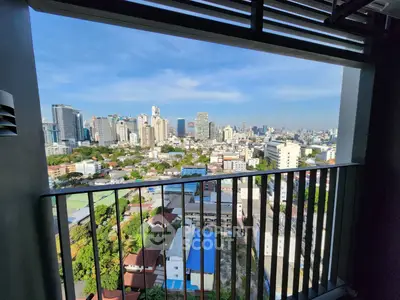 Stunning cityscape view from a high-rise balcony, showcasing urban skyline and vibrant city life.