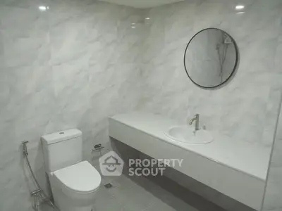 Modern minimalist bathroom with sleek fixtures and marble walls