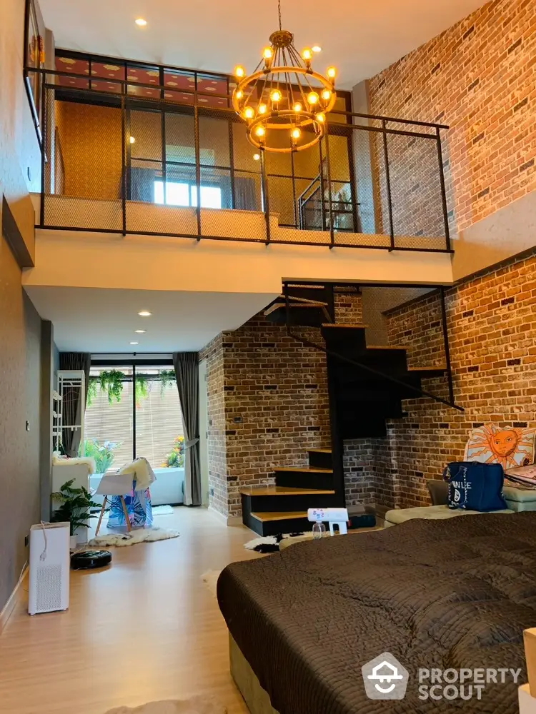 Stunning loft-style living room with brick walls and modern chandelier