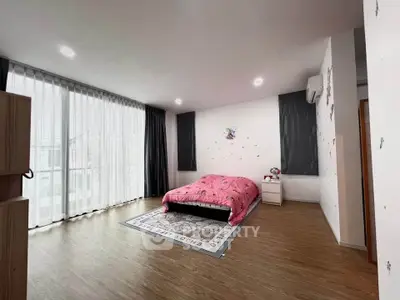 Spacious bedroom with large windows and modern decor