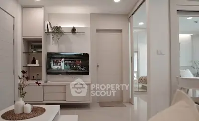 Modern living room with sleek white furniture and built-in TV unit