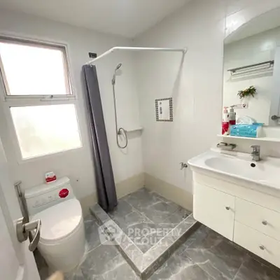 Modern bathroom with sleek fixtures and a spacious shower area.