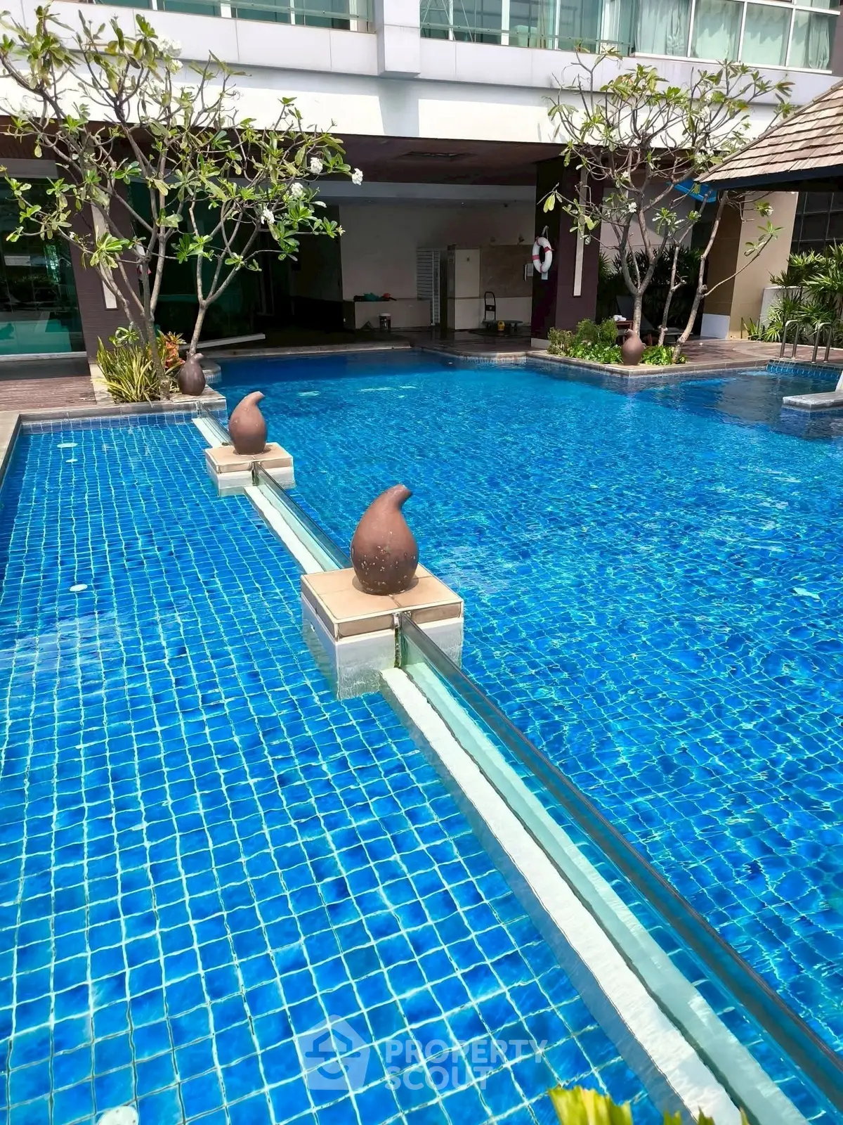 Luxurious swimming pool with elegant design and serene ambiance in a modern residential complex.