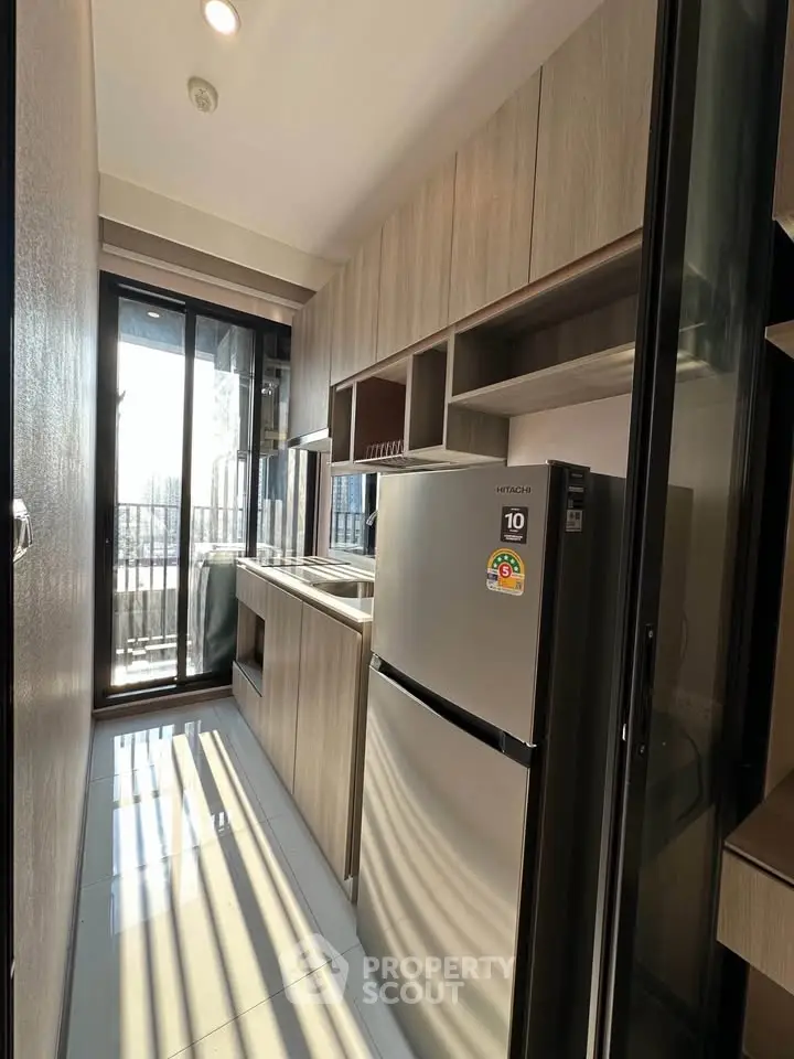 Modern kitchen with sleek cabinetry and stainless steel appliances in a compact layout.
